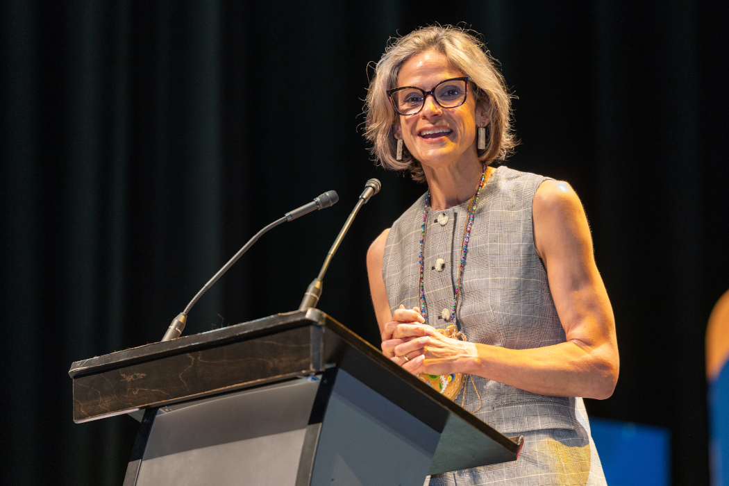 Dr. Sara Goulet speaks at a lectern. 