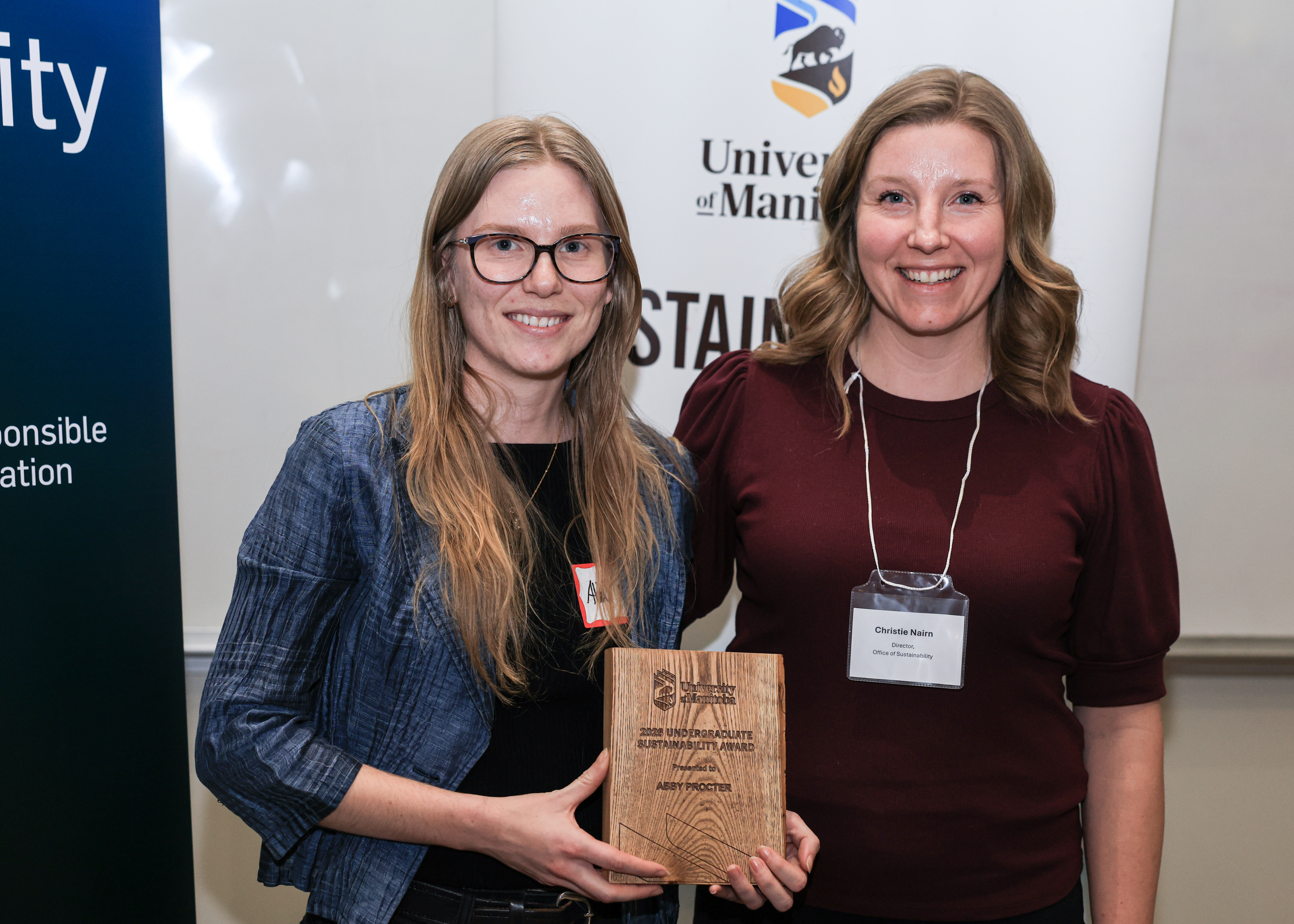 Abby Procter receives wooden plaque from Christie Nairn.