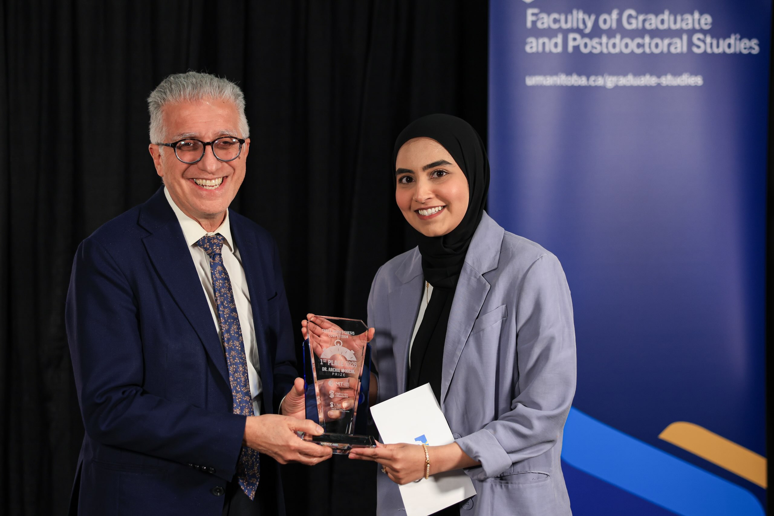 Person receiving an award from UM President.