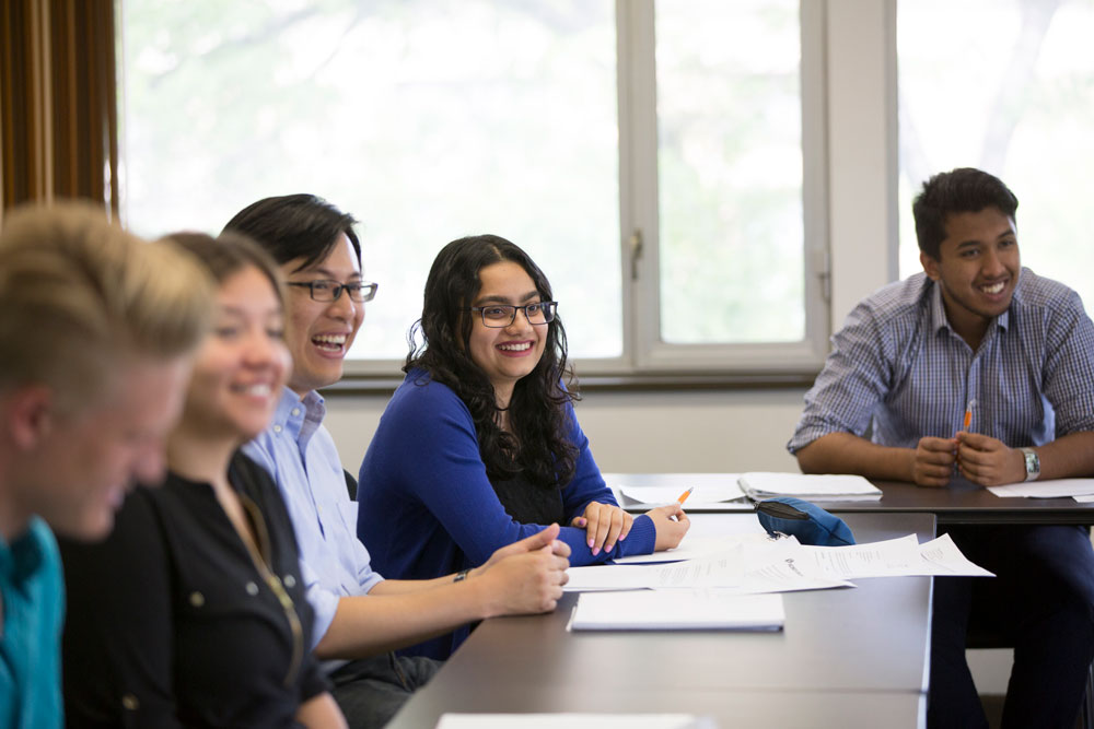 A group of students smiling around a table