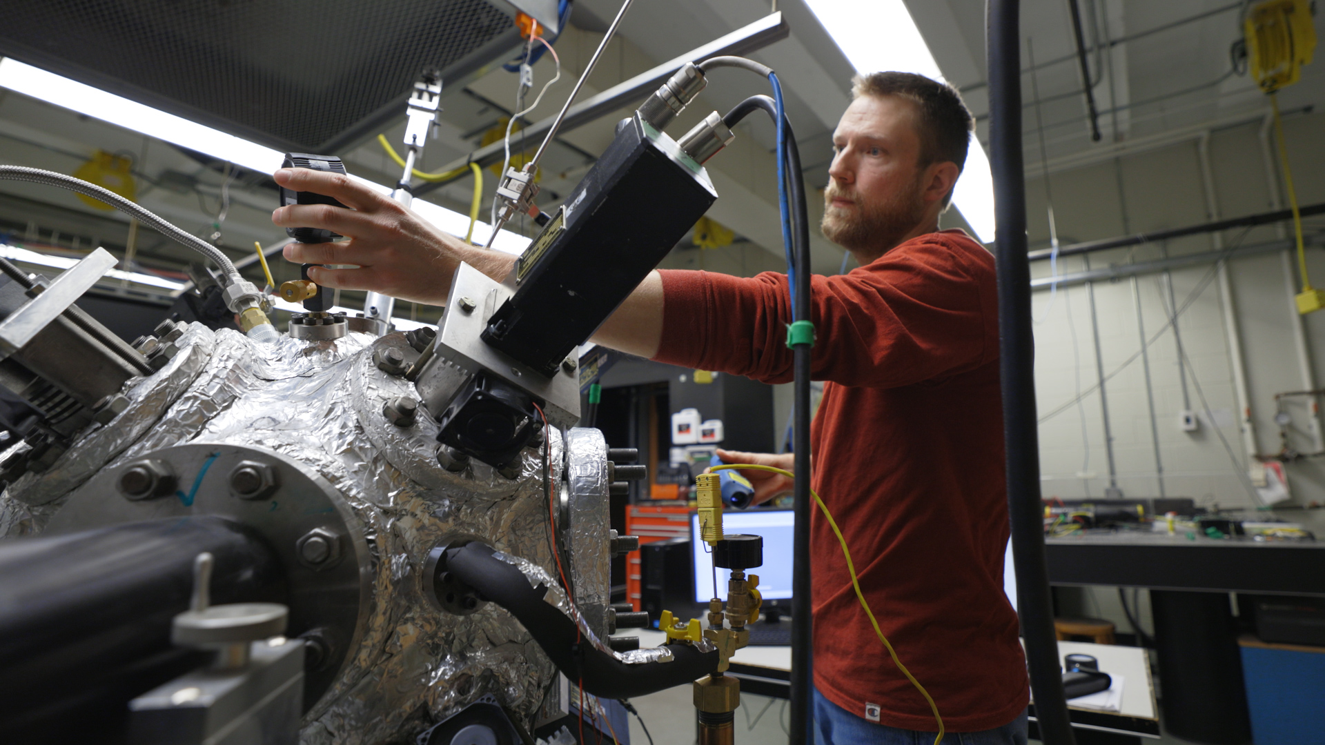 Student tinkers with spherical engine in a laboratory