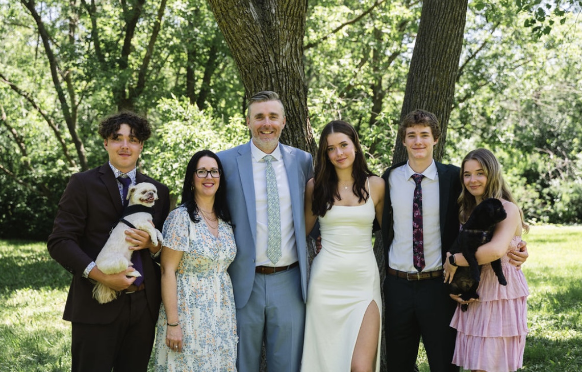 Cameron Dyck (right) holding Moby, with her family (left to right) brother Carter holding Ollie, mom Ginette, dad Brent, sister Addison, and brother Wyatt.