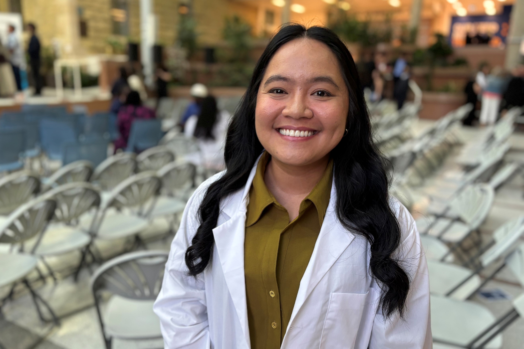 A portrait of Marie Alcantara wearing a white coat. 