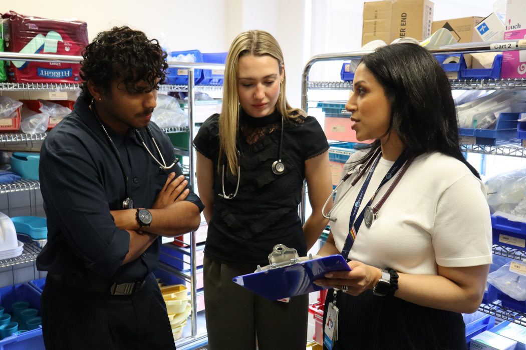 Dr. Mahwash Saeed speaks with two medical students in a hospital.