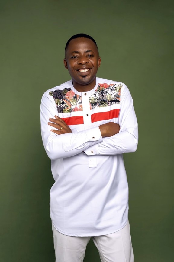 Franck Ghomsi posing against a green backdrop.