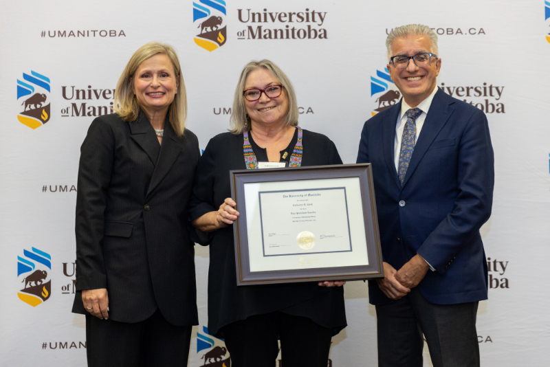Chancellor Anne Mahon and President Michael Benarroch present award to Catherine Cook.