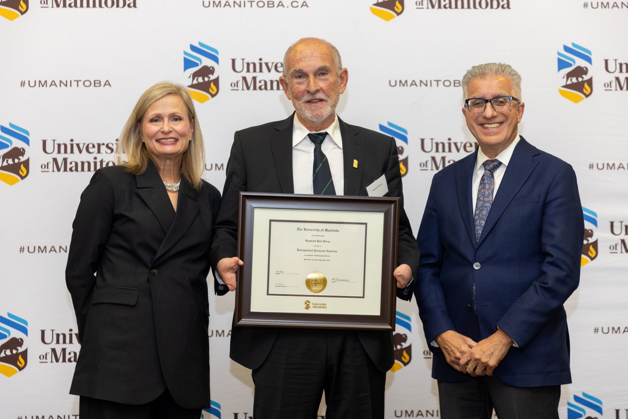 Chancellor Anne Mahon and President Michael Benarroch present award to Raymond Perry.