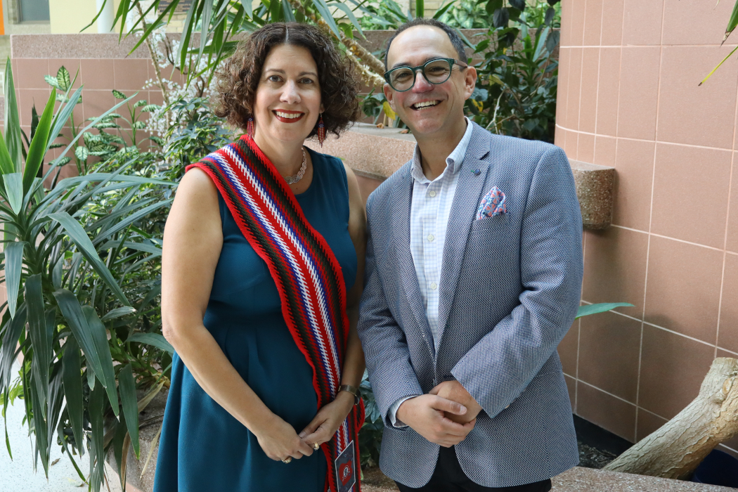 Dr. Michelle Driedger and Dr. Nathan Nickel pose for a photo. Driedger is  wearing a Métis sash.