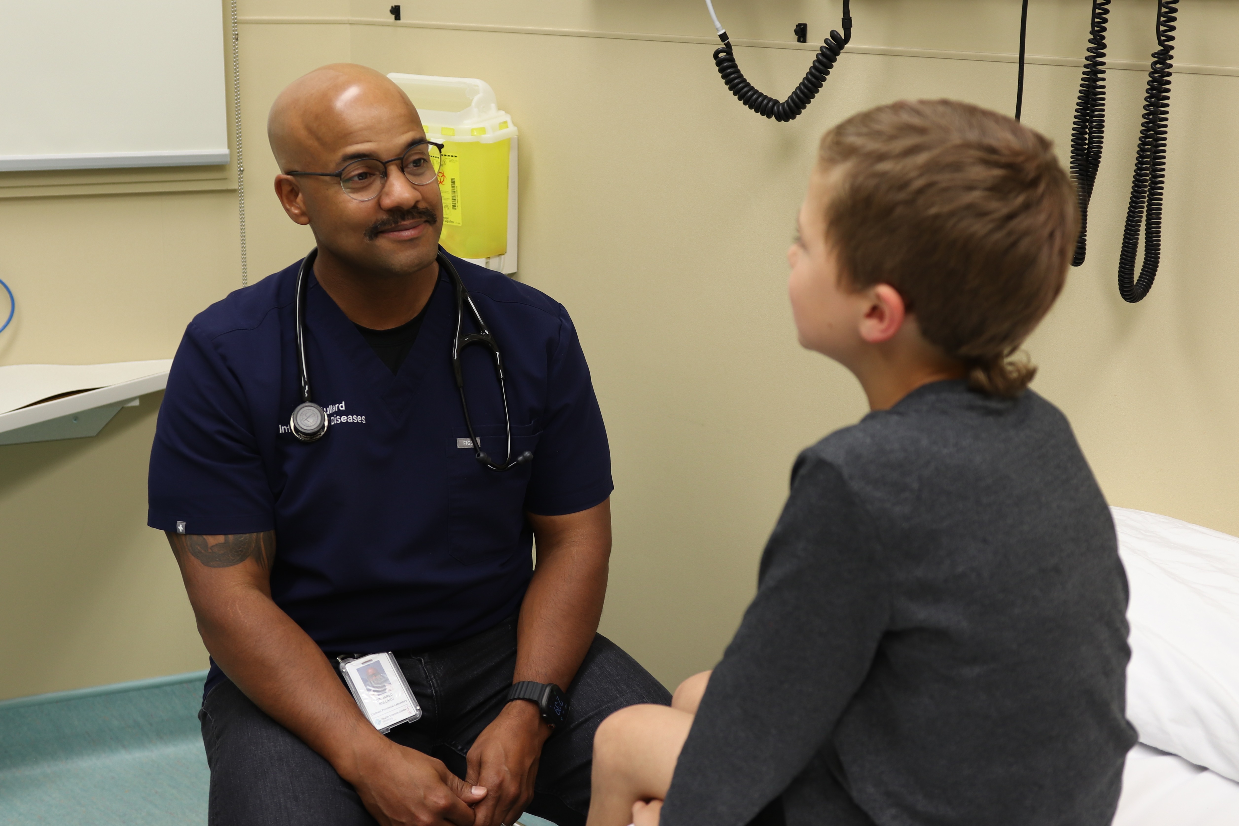 Dr. Jared Bullard and a child in an examination room.