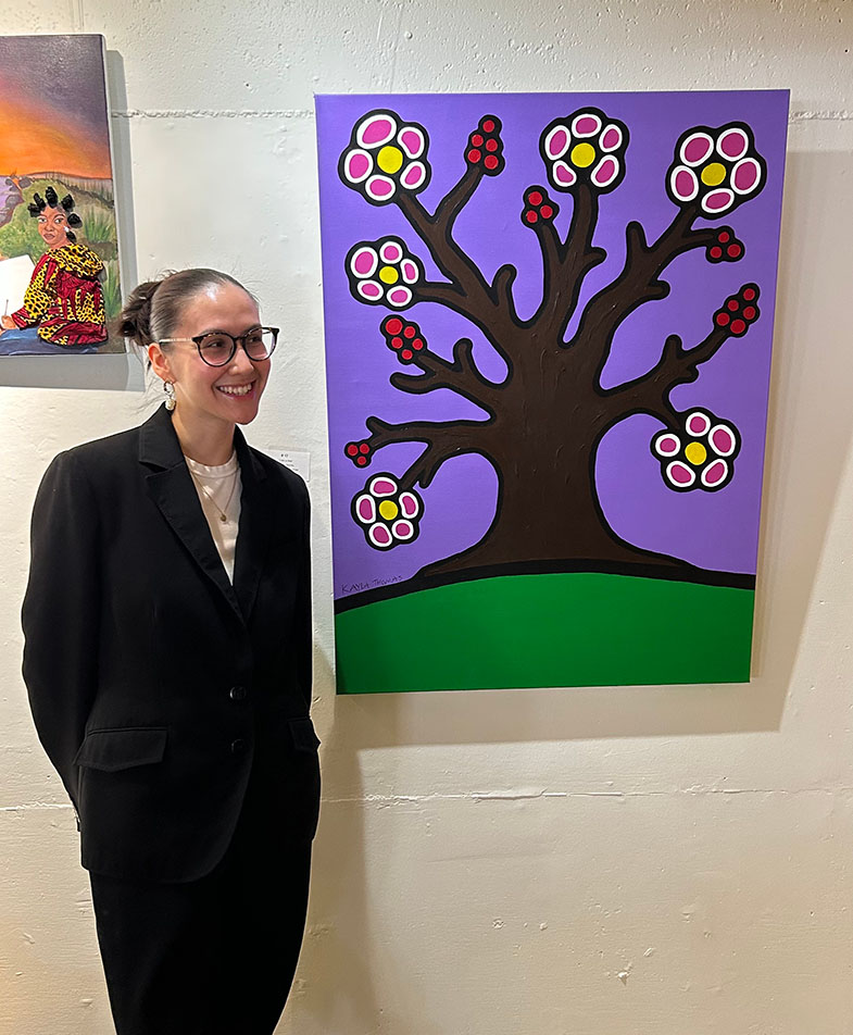Kayla Thomas, with her painting expressing how she is resilient, grounded, beautiful and unique, 