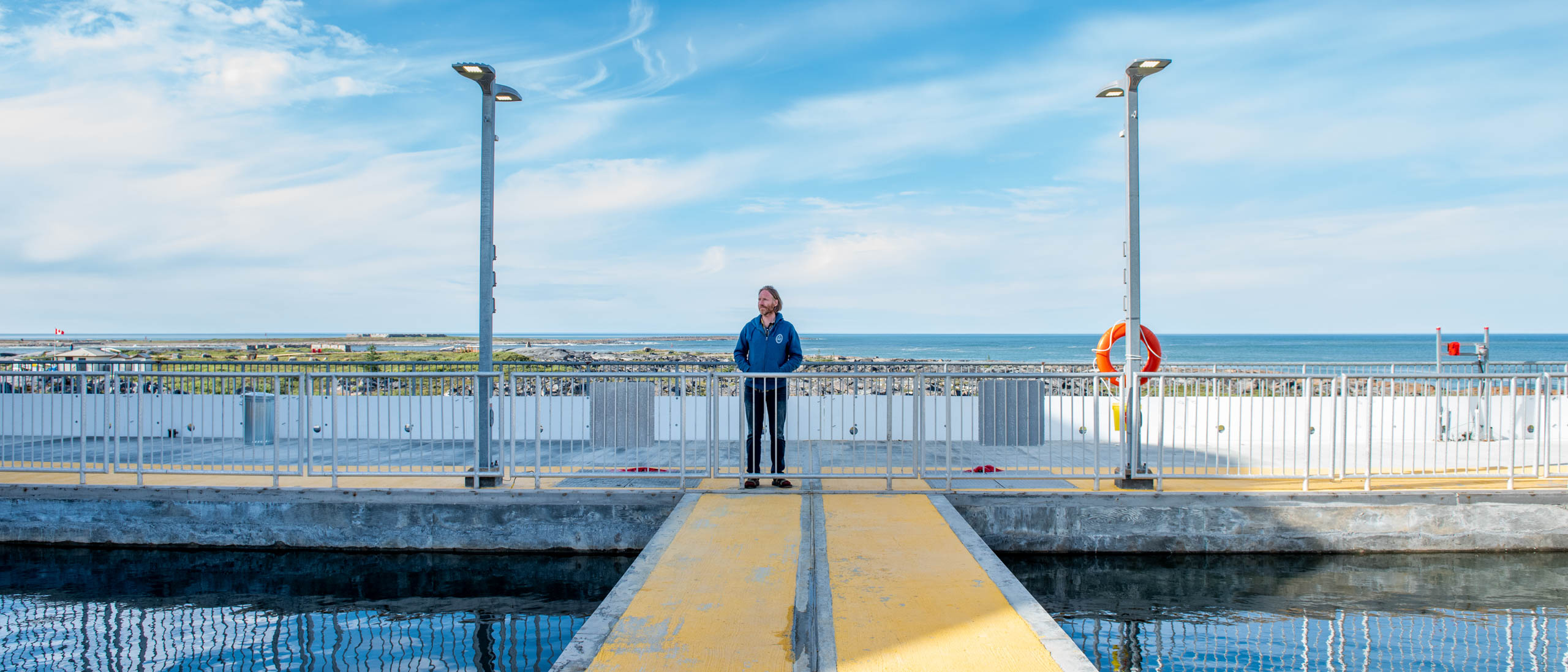A man stands on a dock 