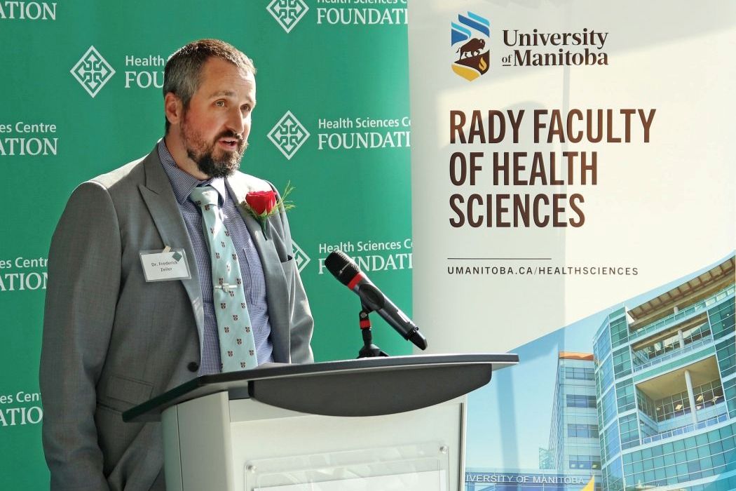 Dr. Frederick Zeiler speaks at a lectern. 