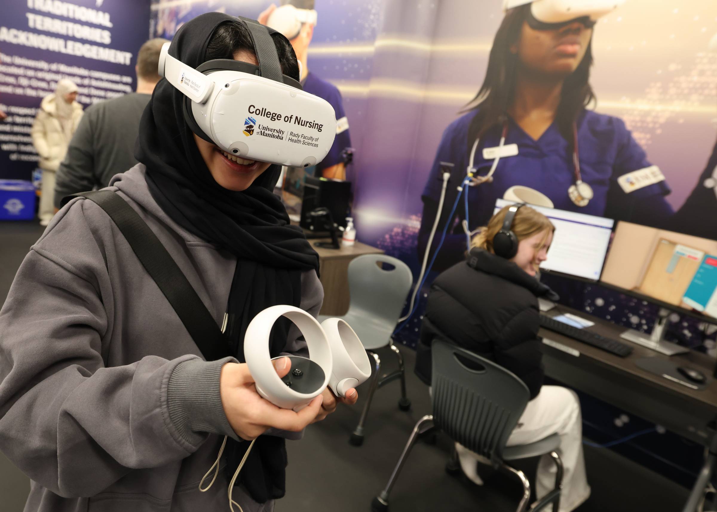 A woman holding controllers and wearing virtual reality goggles with a label reading College of Nursing.