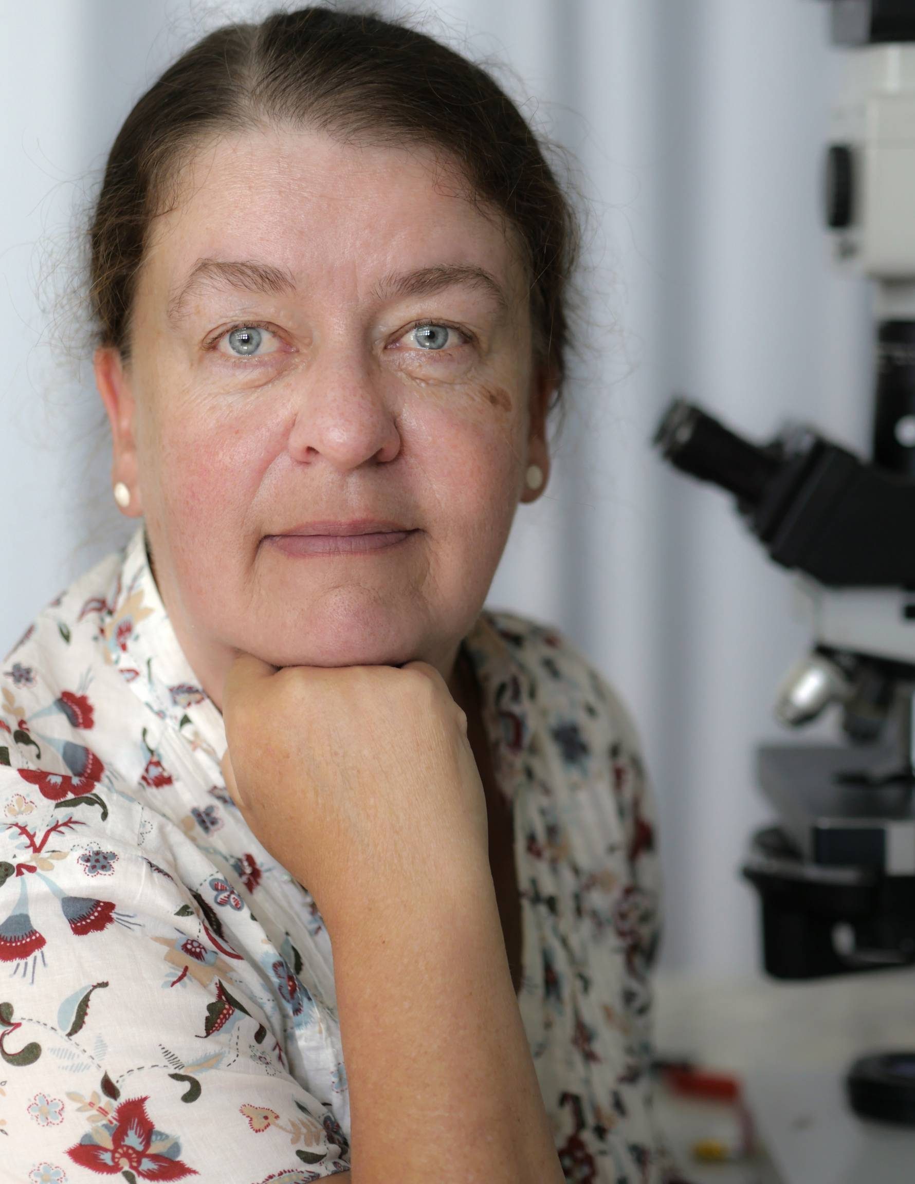 Dr. Sabine Mai poses with her microscope.