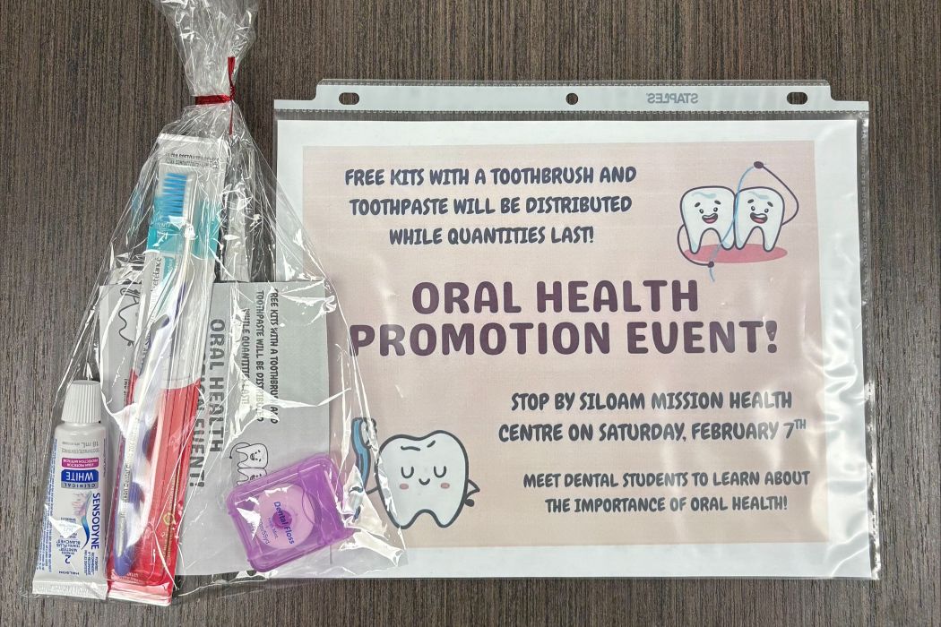 A oral hygiene kit that contains a toothbrush, toothpaste and dental floss. And a sign promoting the event.