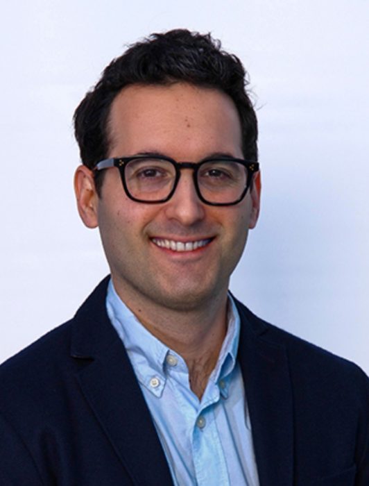 A smiling man with glasses