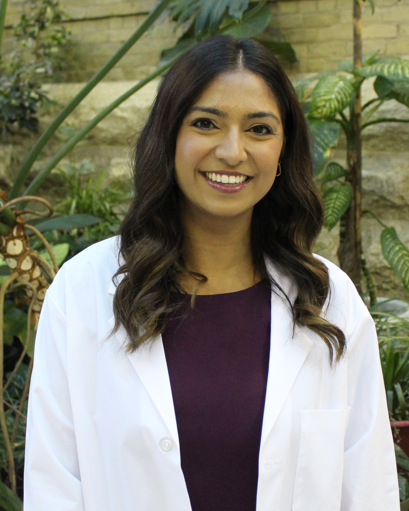 Portrait of Shivani Bharkhada. She is wearing a white coat.