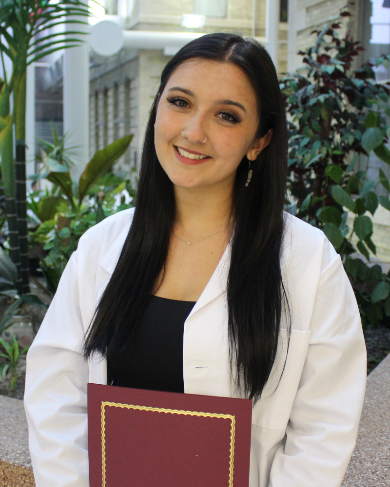 Portrait of Priya Meyler. She is wearing a white coat.