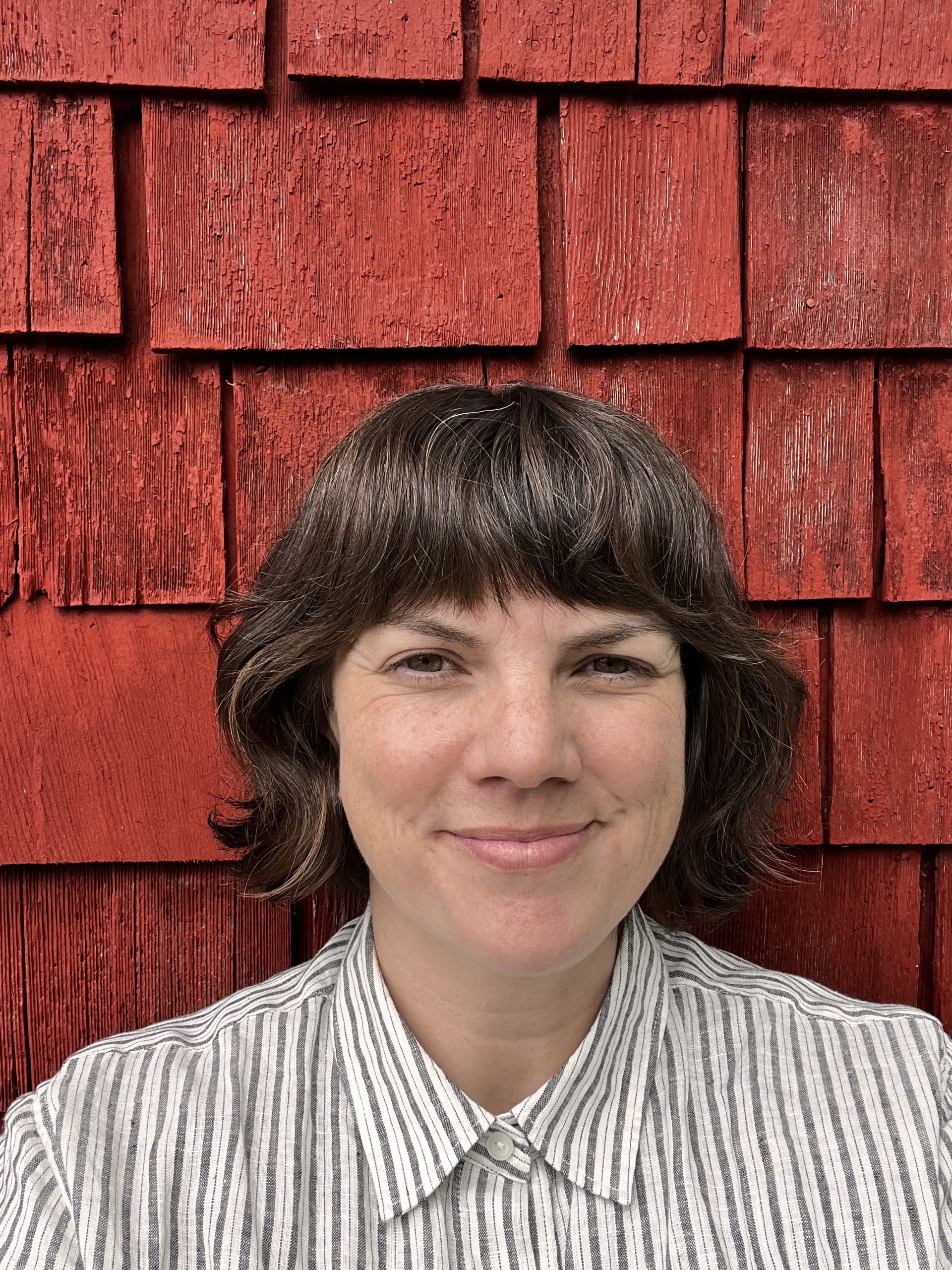 A woman in front of a wall.