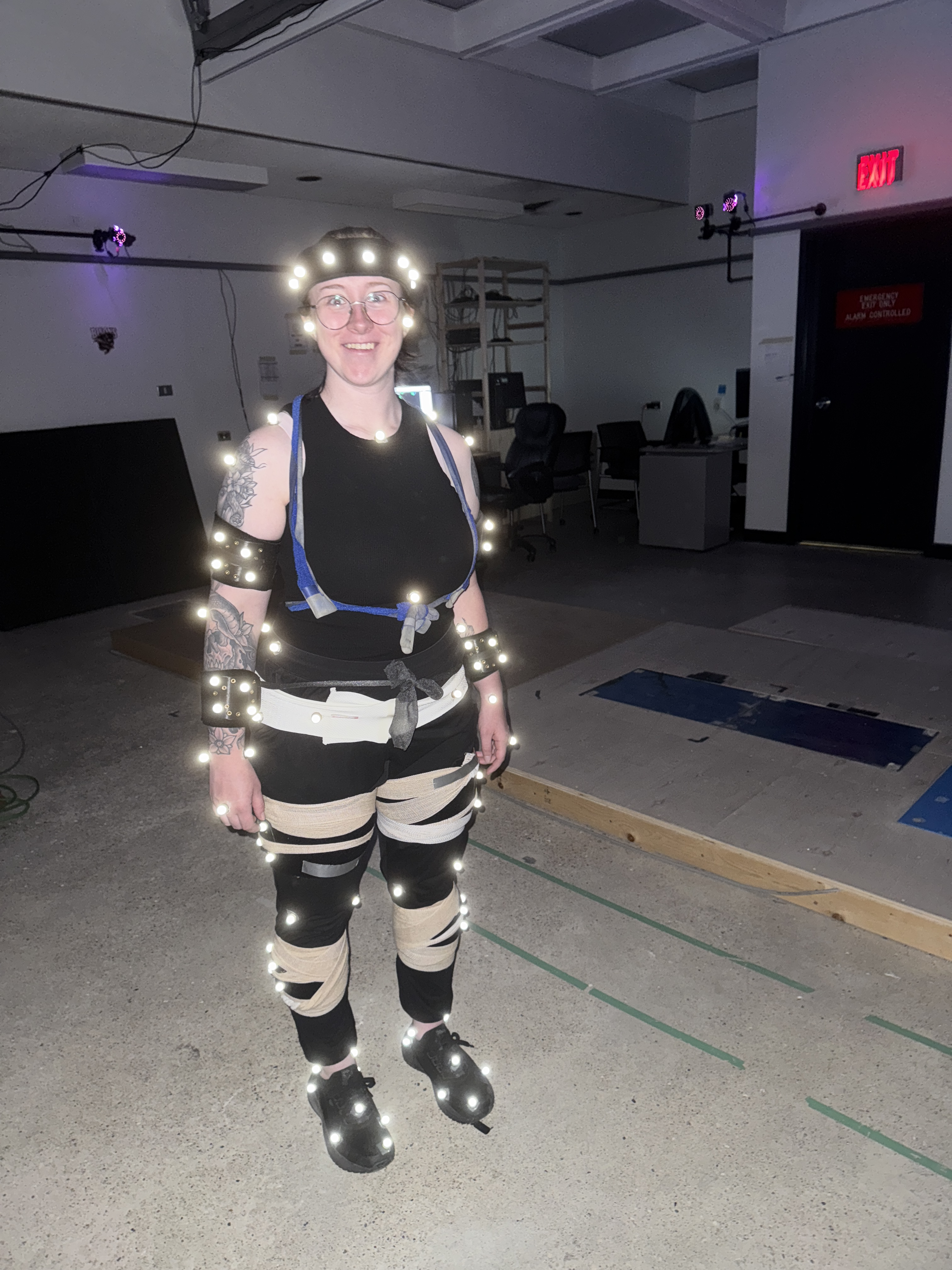 Emma Heath covered in light up tracking dots in a lab