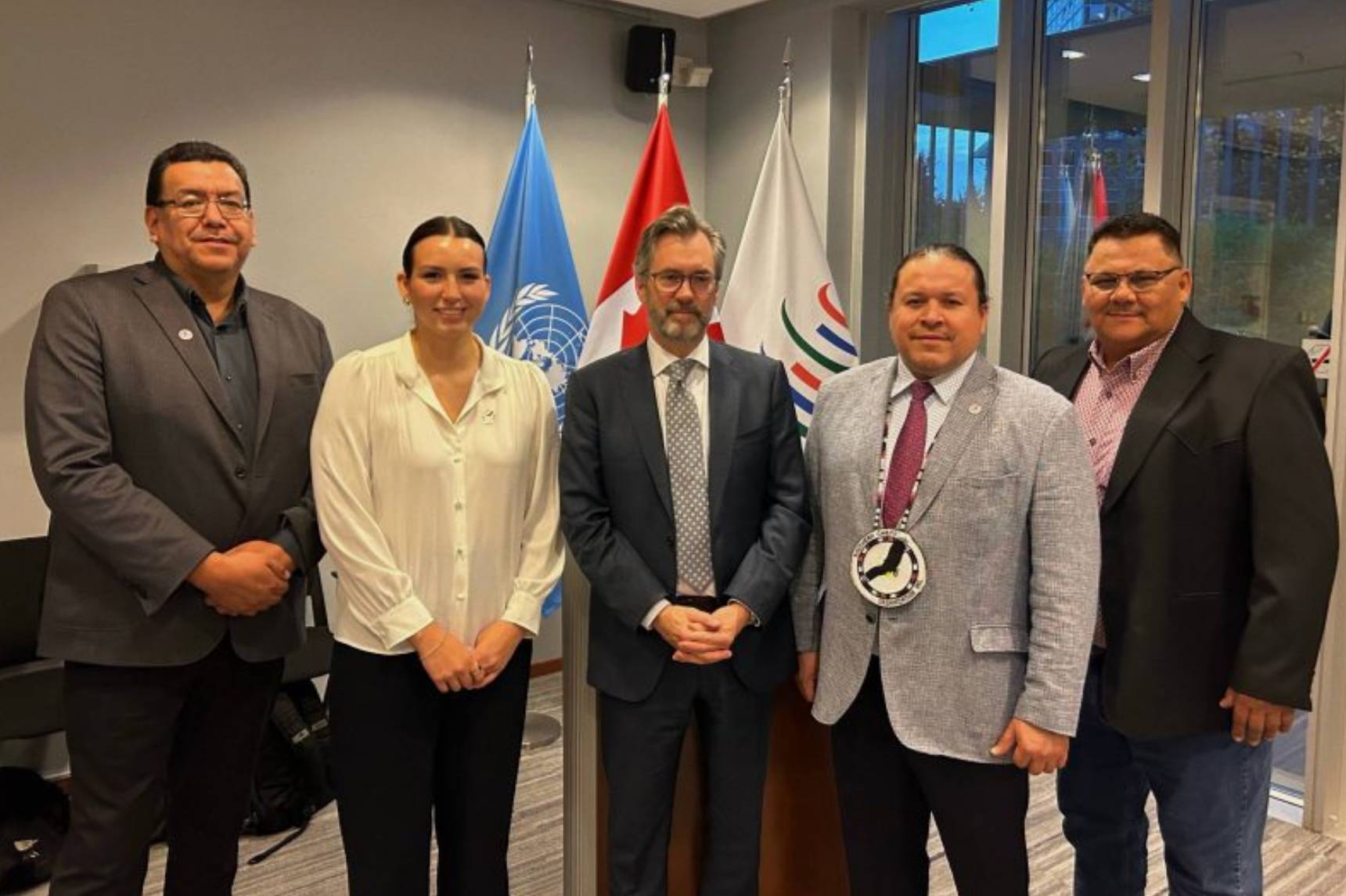 Five people pose for a photo.