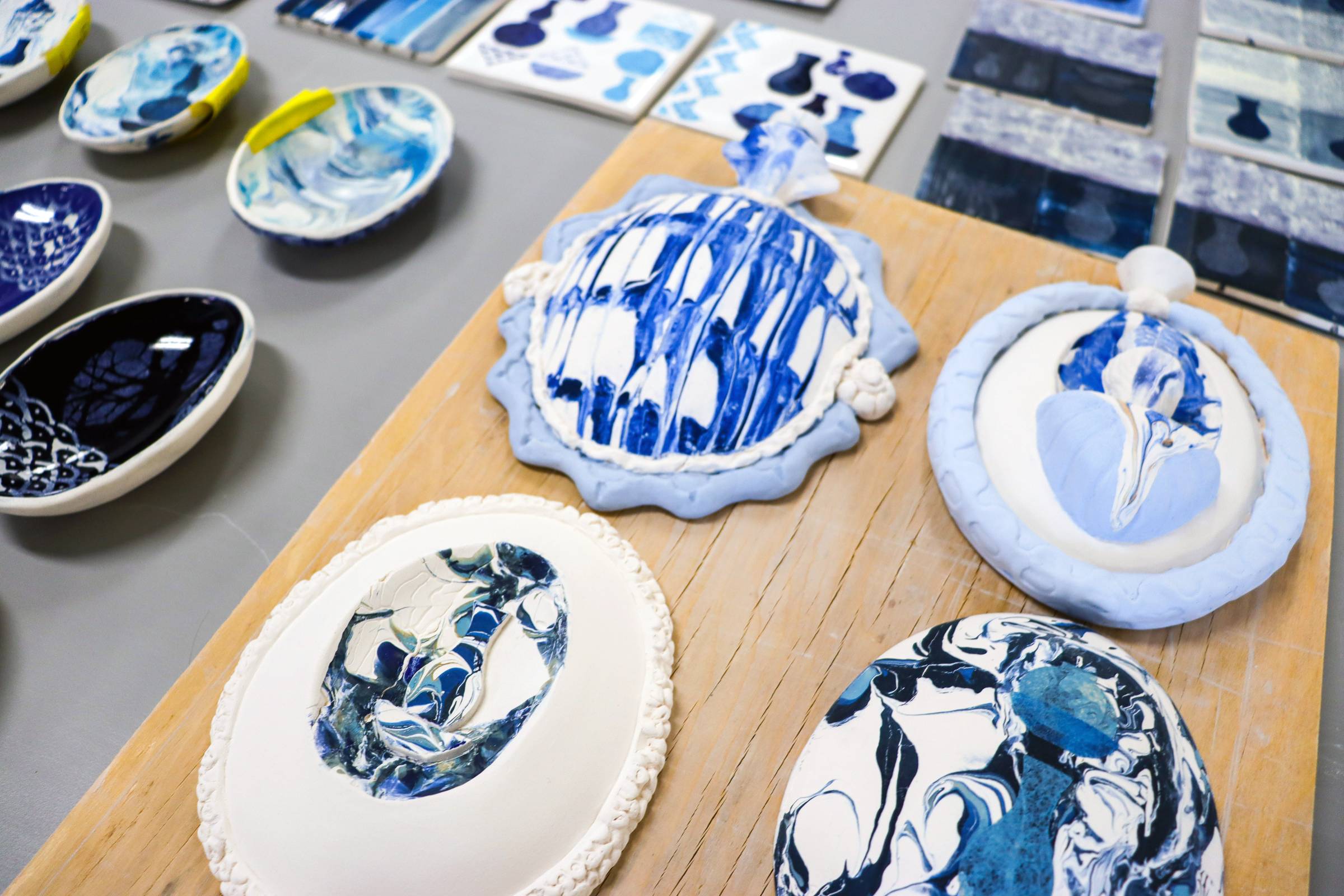 ceramics painted in different shades of blue laid out on display.