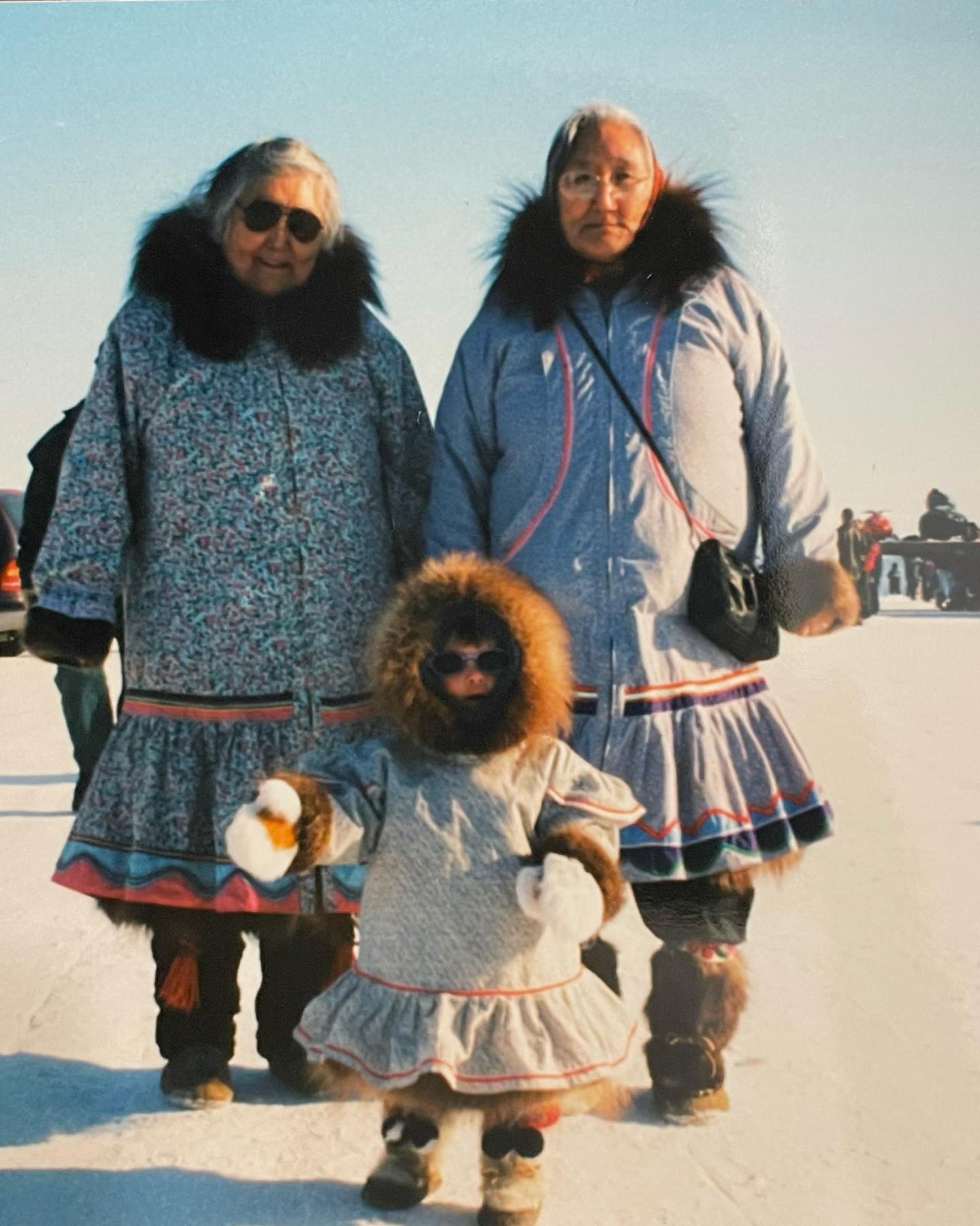Willow Allen poses in a parka with family as a child living in the Arctic.