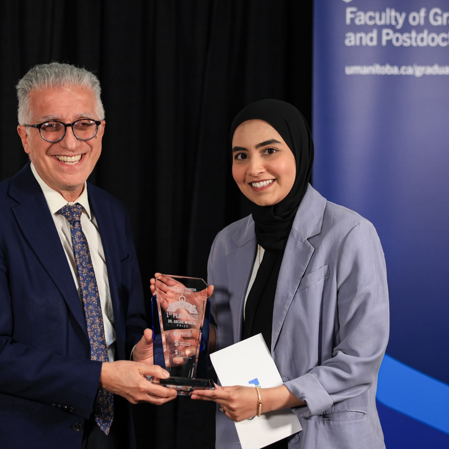 Person receiving an award from UM President.