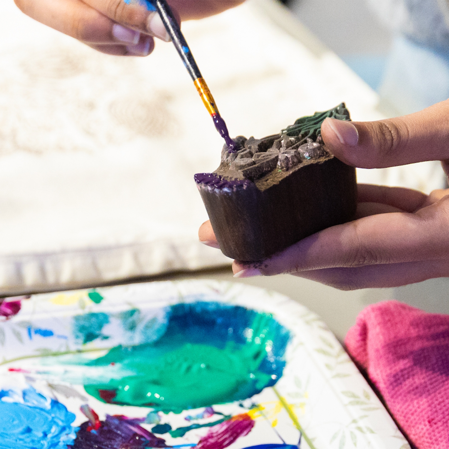 Ebunoluwa Akinbo painting a carved blocked to do block printing