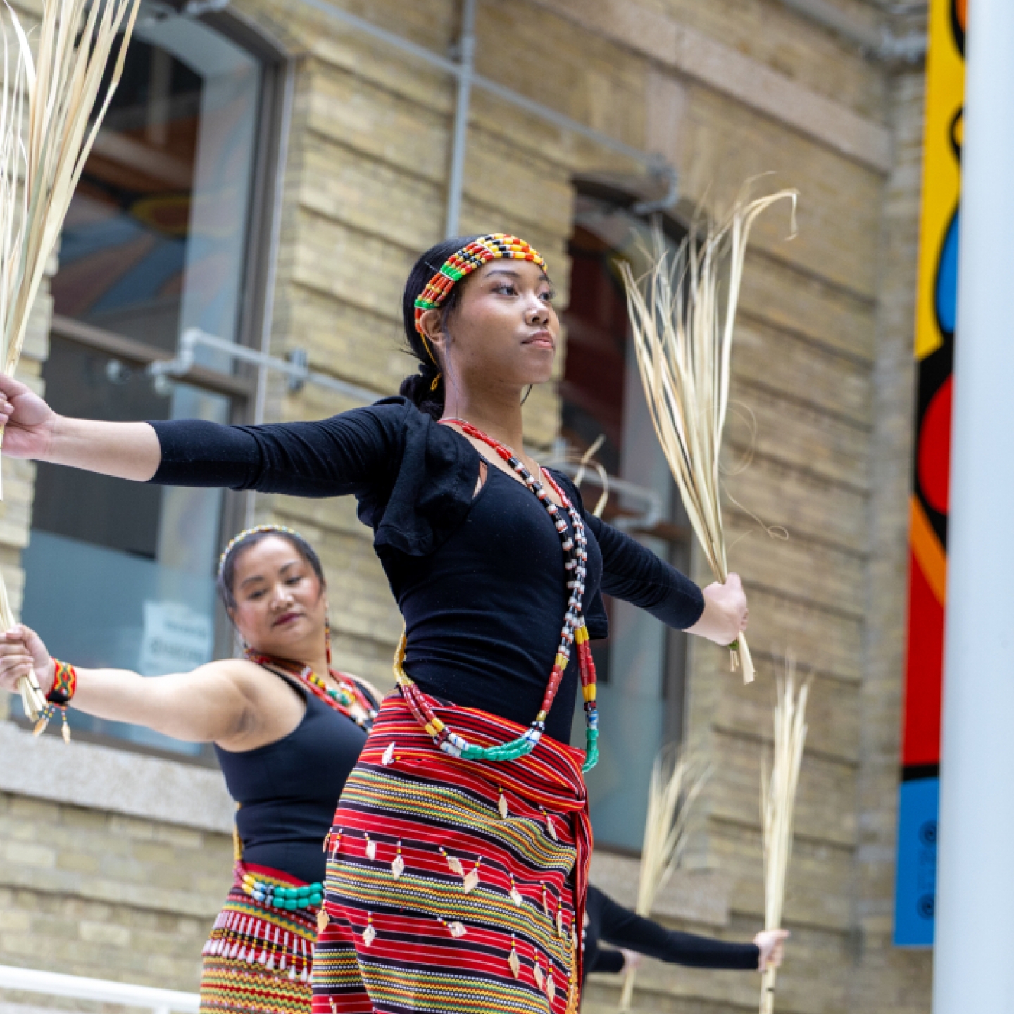 Two dancers wearing traditional Filipino clothing. 