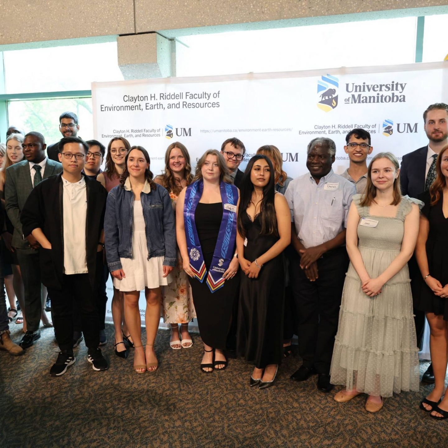 A large group photo featuring many graduating students from the 2025 Spring Convocation Reception.