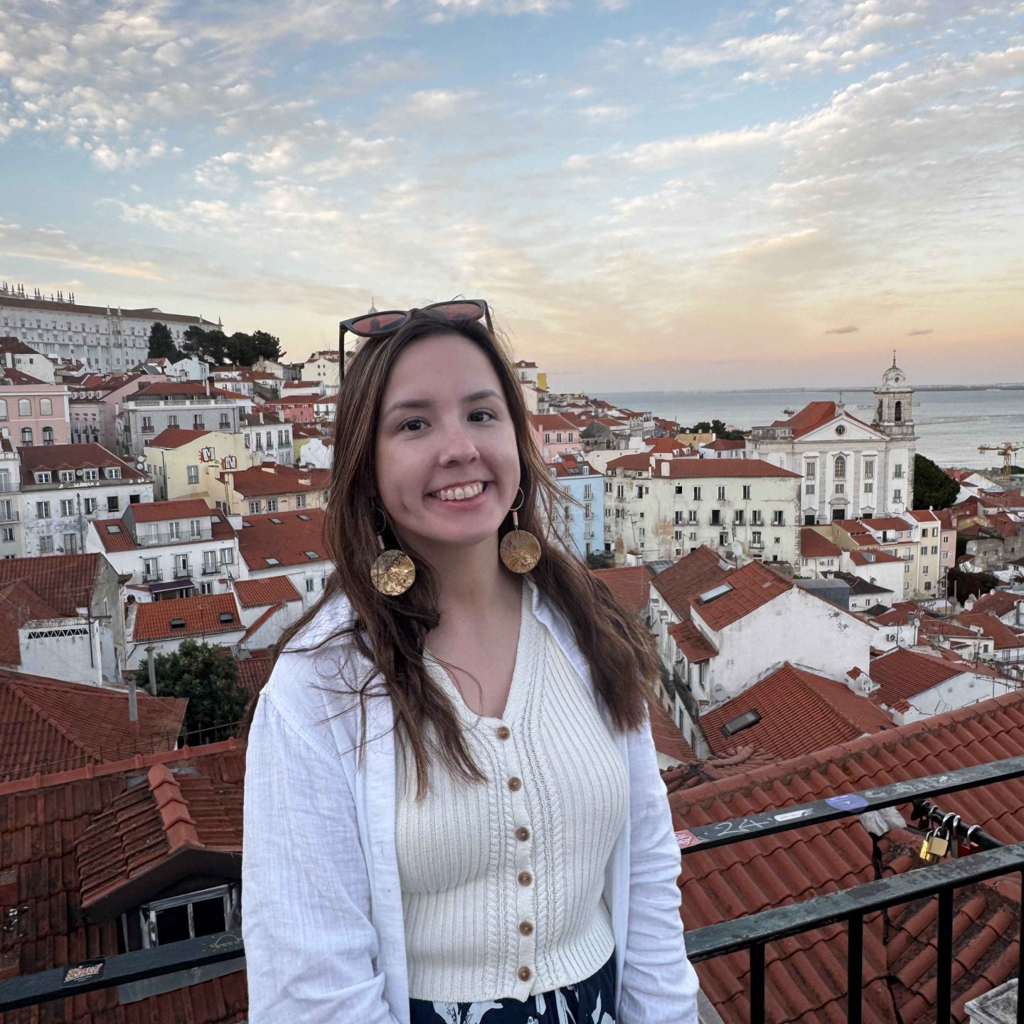 Female smiles for portrait with sunset background. 