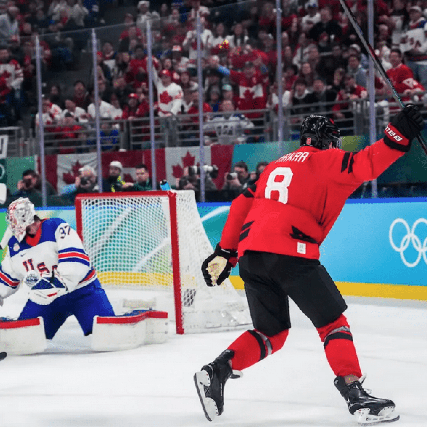A Team Canada hockey player celebrates scoring a goal 