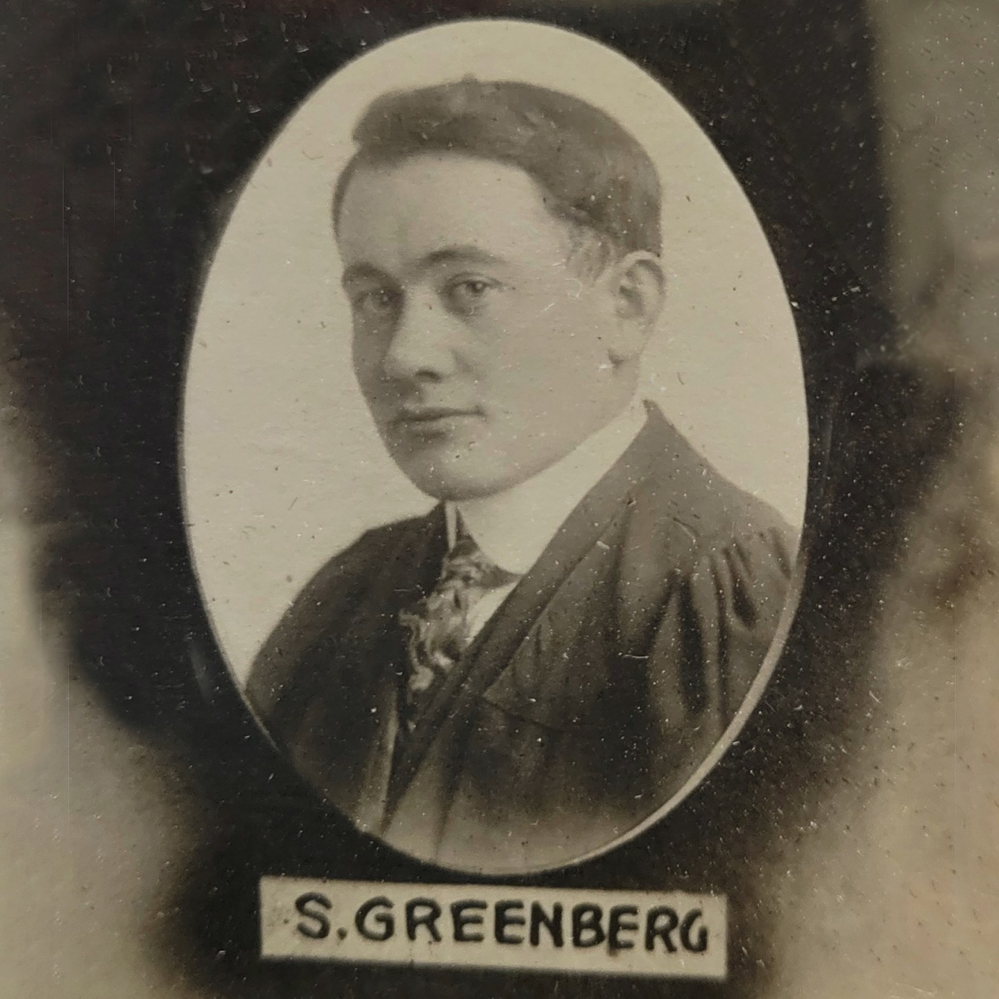 an old fashioned oval portrait of a young man from 1918 marked S Greenberg