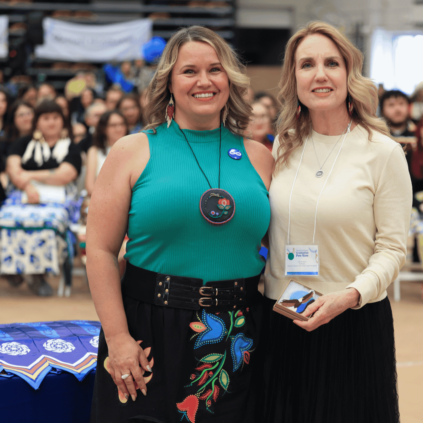 Student Tammy Nelson standing with Migizii Award winner Dr. Kendra Nixon