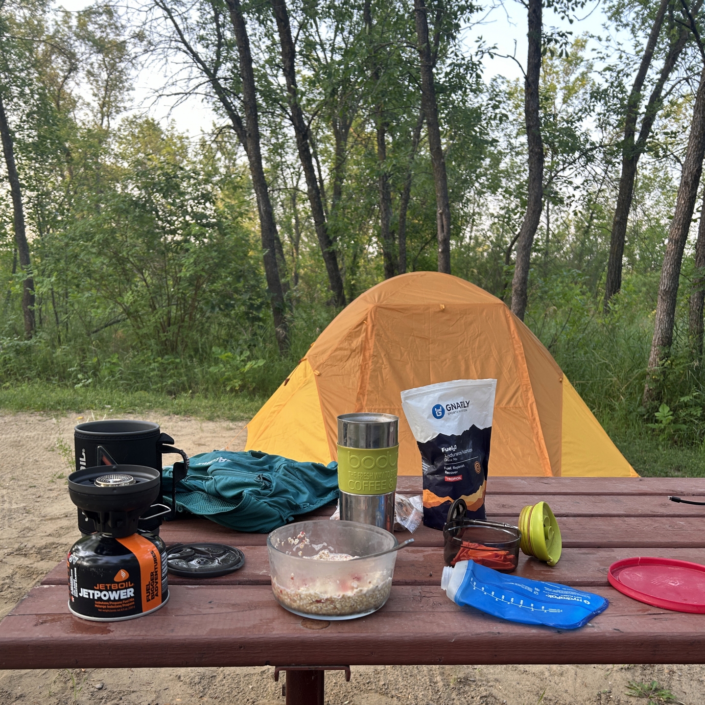 Orange tent and a picnic table