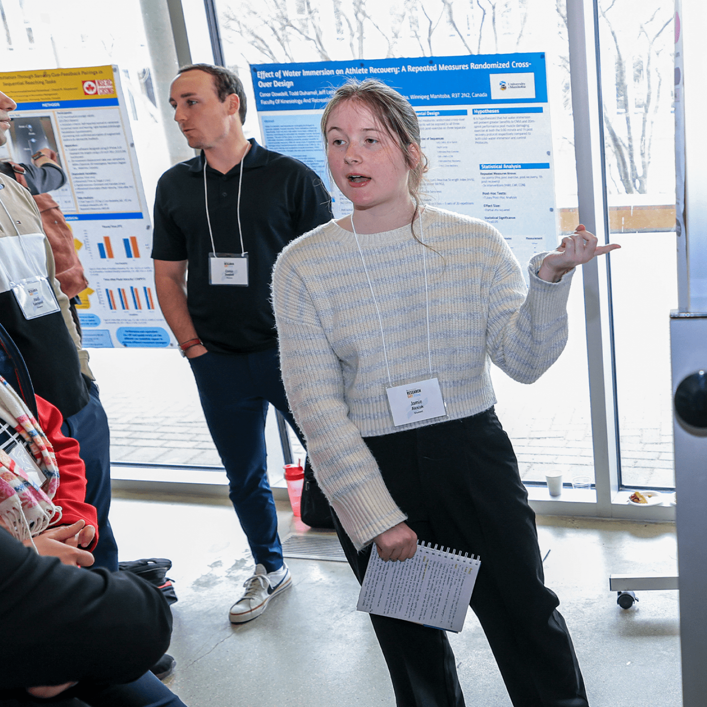 A student talks to a professor about their poster at Research Day 2026.