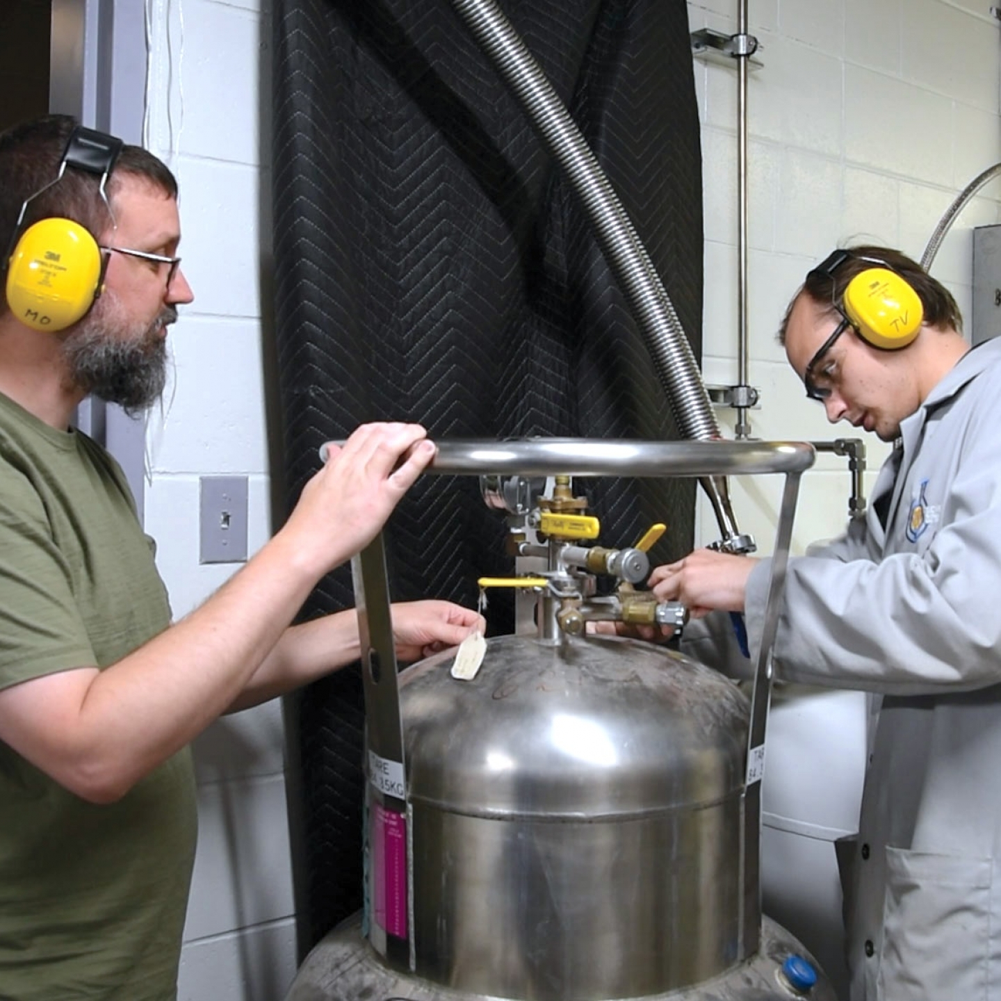 Tim Vos and Michael Opyr working inside the Helium recycling room.