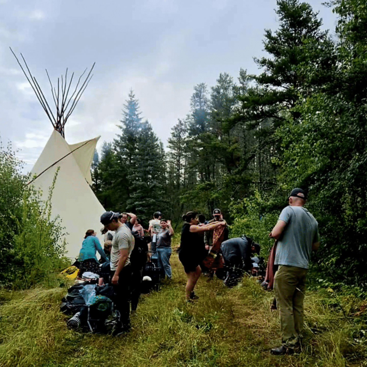 students exploring the Land with tipi in background