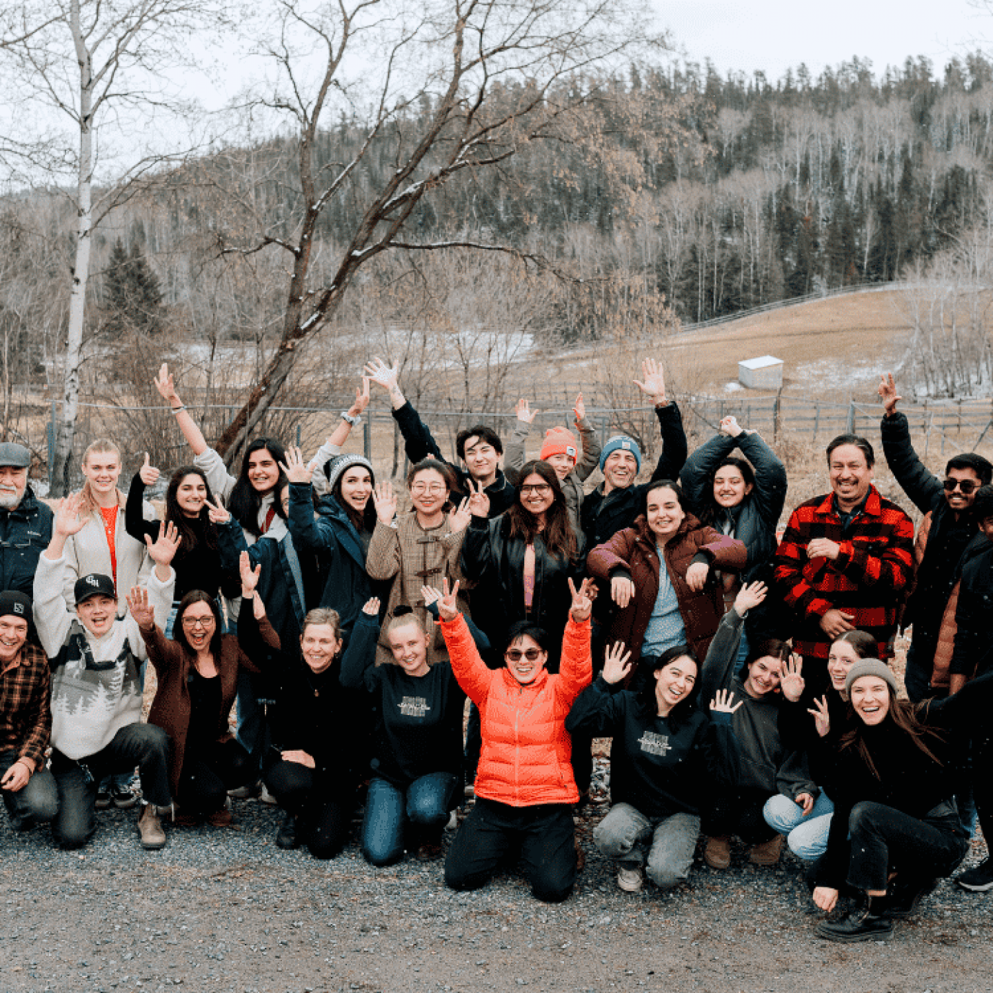 5. Participants pose together outdoors during a community gathering and learning retreat.