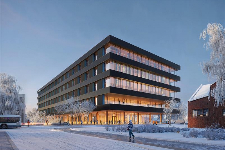 Four story building with lots of windows in the winter time at dusk