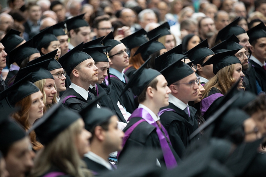 Students wearing caps and gowns at convocation.