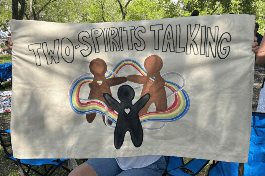 Two-Spirits Talking banner displayed at an outdoor community event.