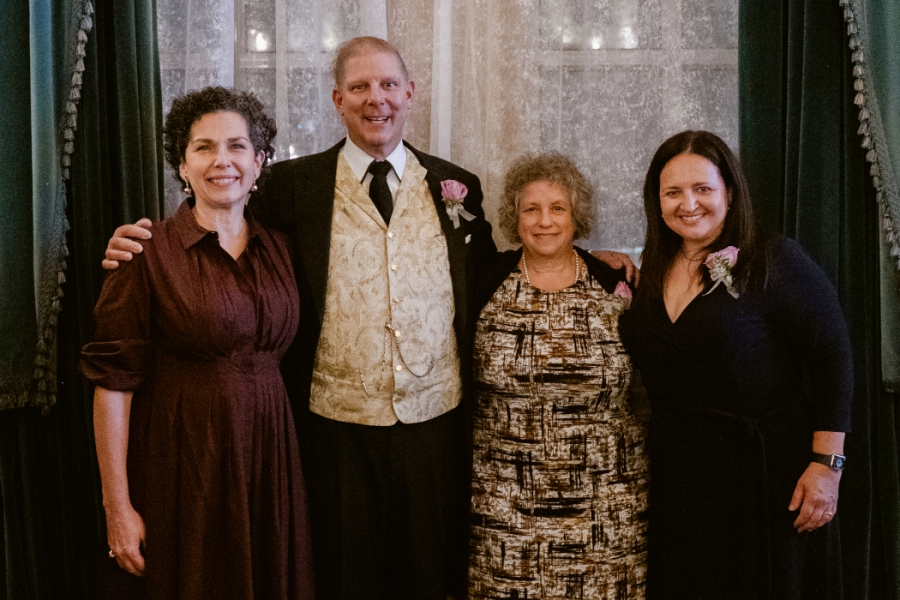 Four people pose for a photo. 