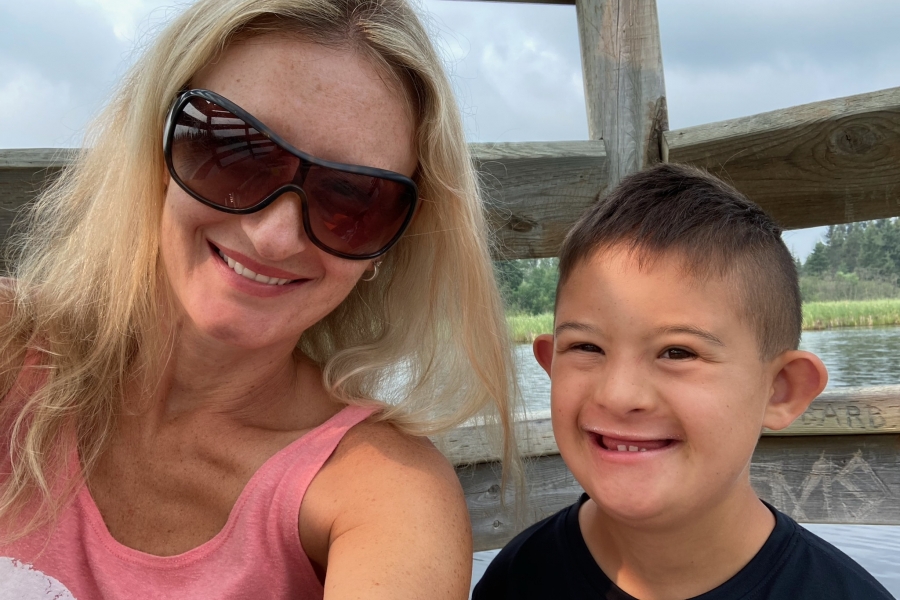 Selfie of a mom and her young son with Down syndrome.