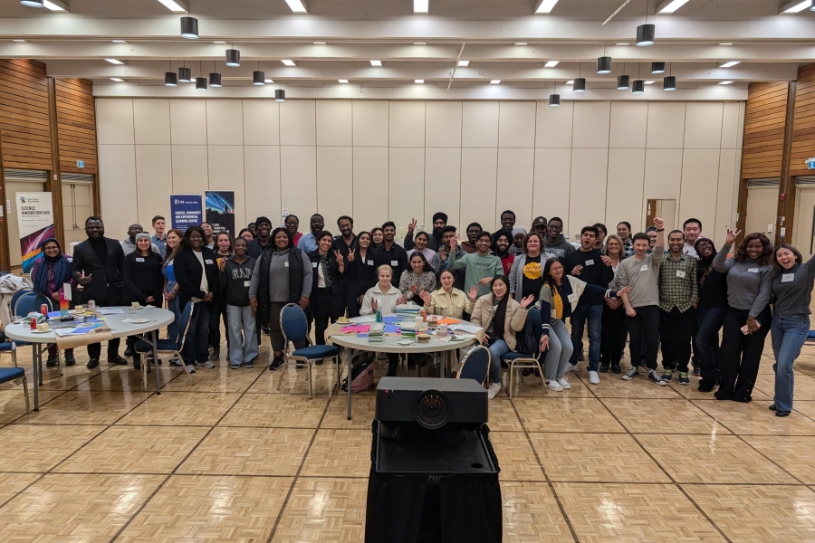 Group photo of a large number of people in a large open indoor space