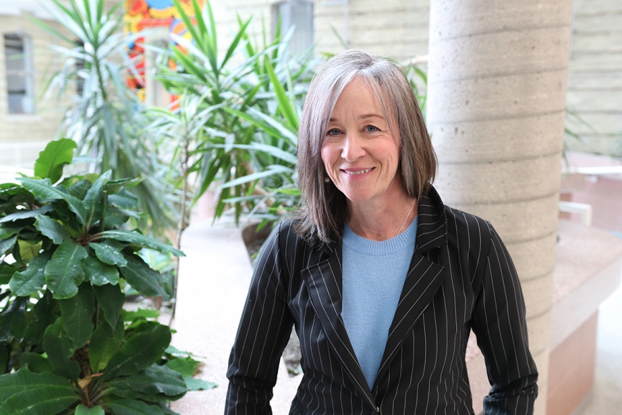 Catherine Bilyeu standing in the atrium at Bannatyne campus.