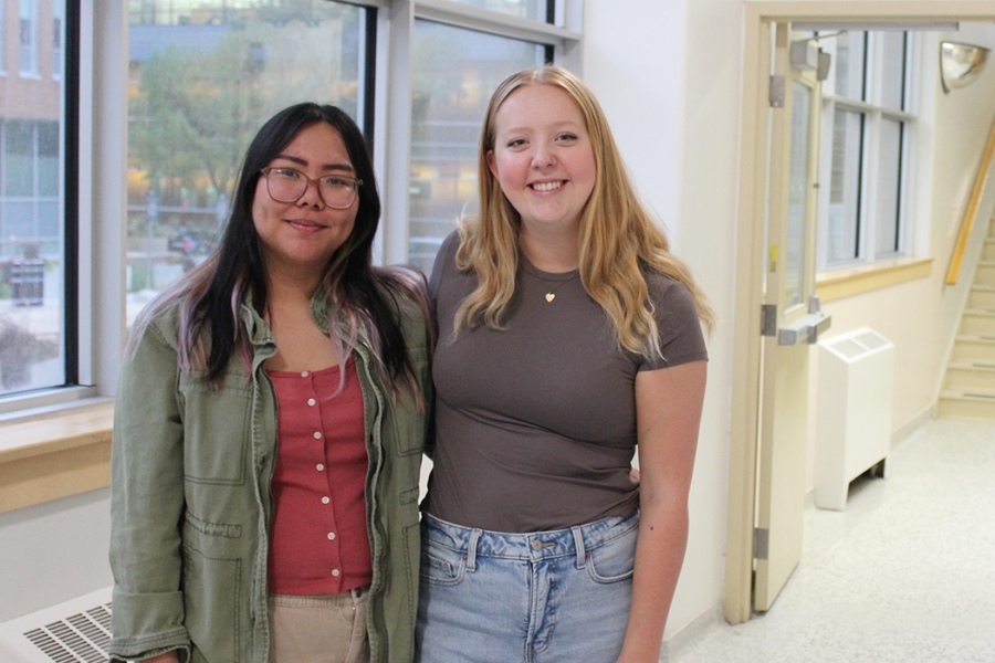 Czynara Gerard Patio and Maya Blair standing in a hallway at the College of Rehabilitation Sciences.