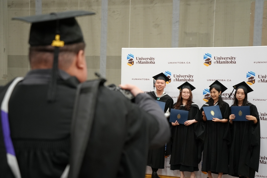 Graduates at a convocation get their picture taken