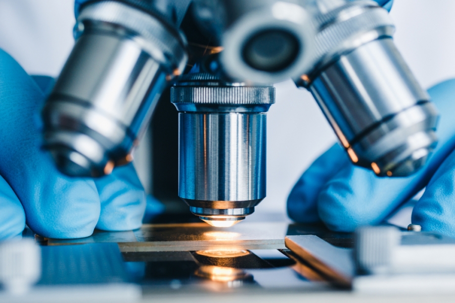 Close up of someone using a microscope. 